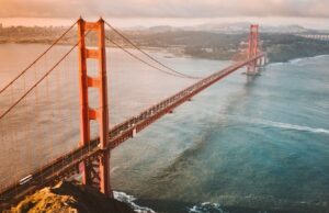 YA Law Corporation E-2 Treaty Investor Visa FAQ for Canadian investors, featuring the U.S. flag, Statue of Liberty and New York skyline USA Vancouver Immigration lawyer at YA Law Corporation
